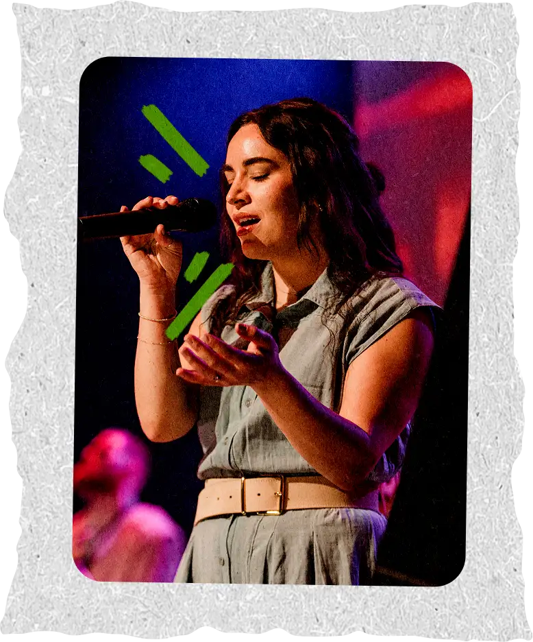 A student leading worship on stage